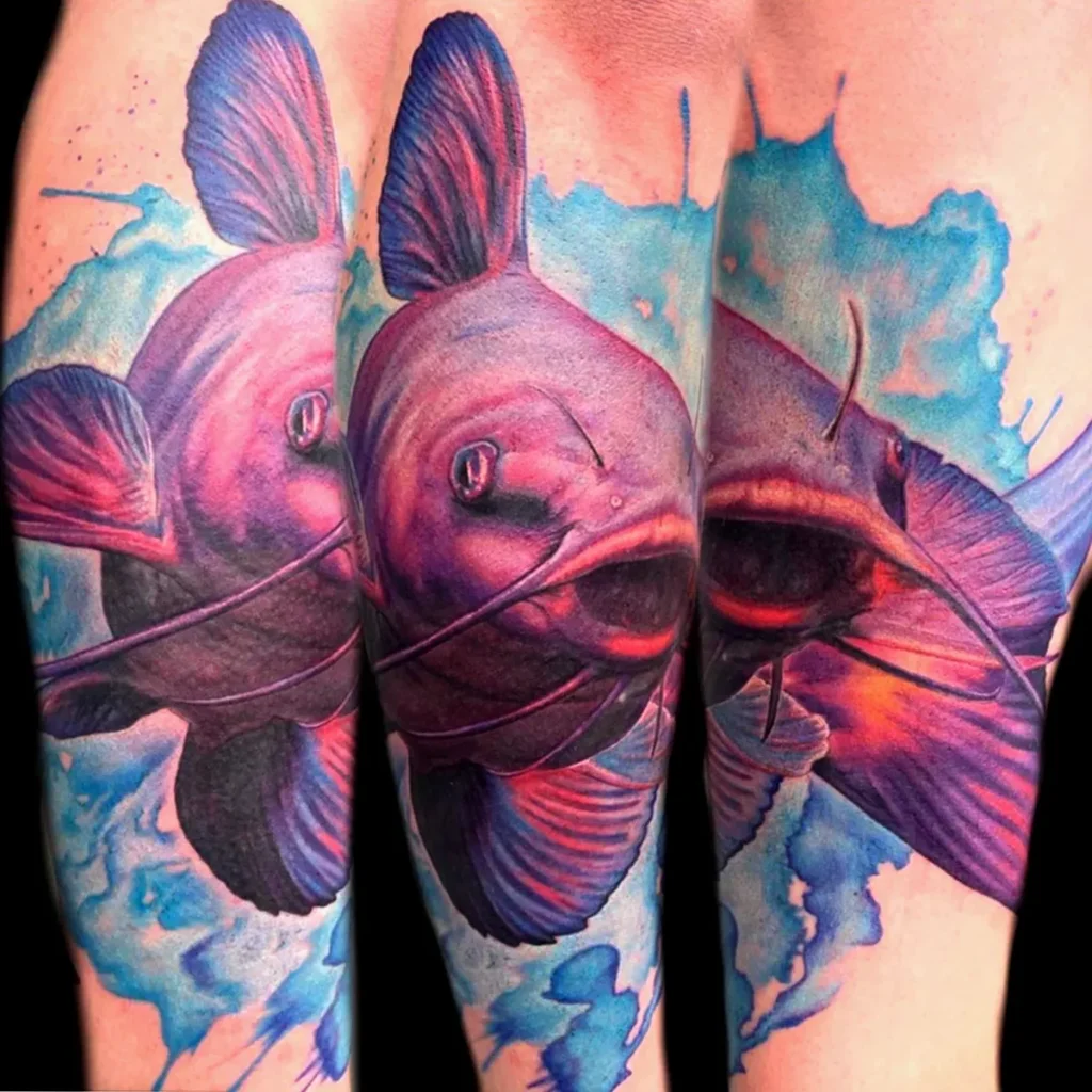 Color catfish tattoo with soft blended tones and flowing aquatic background shapes.