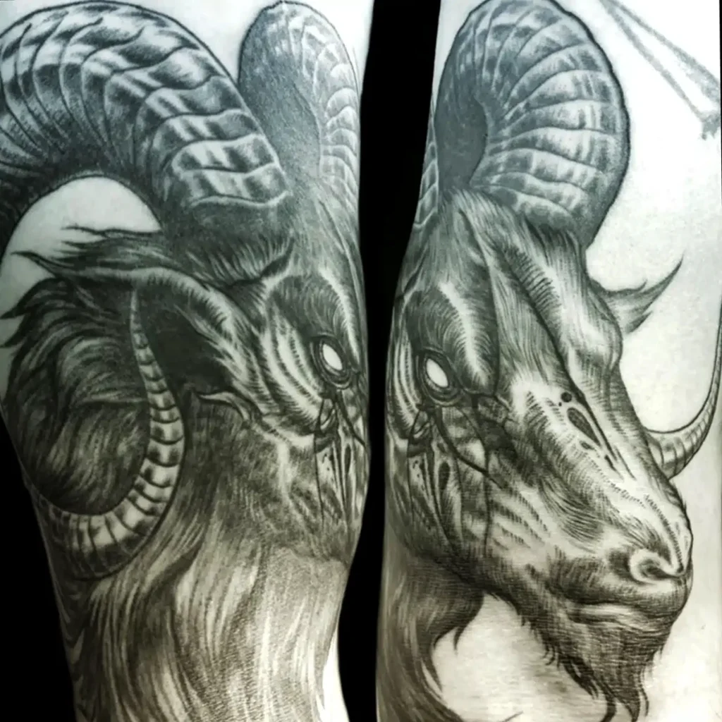Black and grey ram head tattoo with detailed horns.