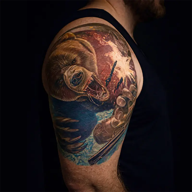 Realistic color shoulder sleeve tattoo featuring a roaring bear, hunting rifle, and outdoor wilderness scene.